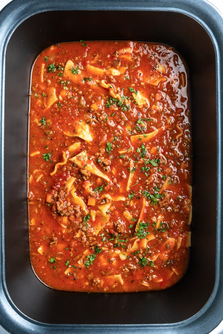 The cooked lasagna soup in the slow cooker.
