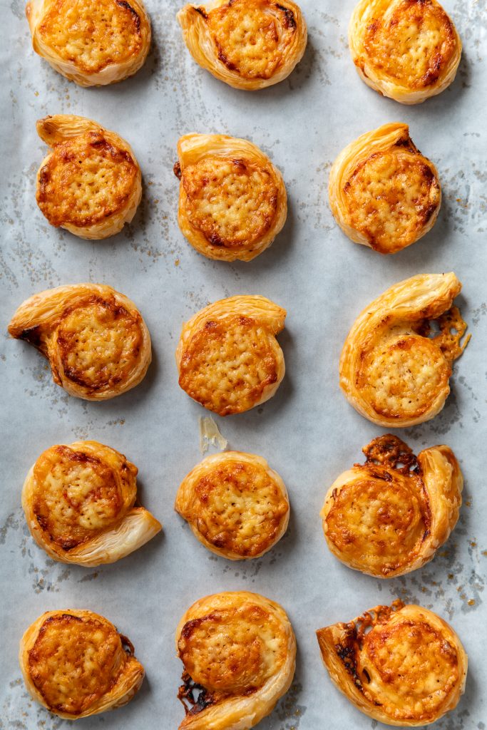 The baked puff pastry pinwheels on the baking tray.