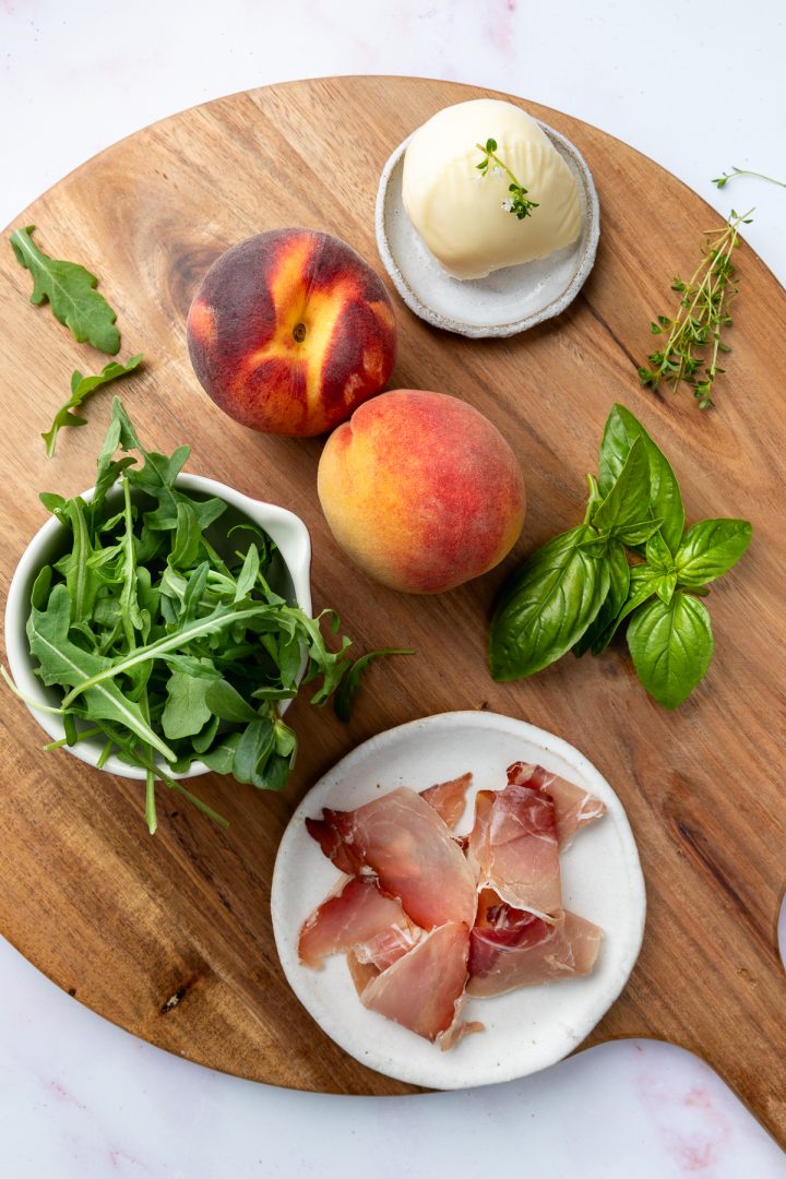 Ingredients needed to make the recipe placed on a wooden board.