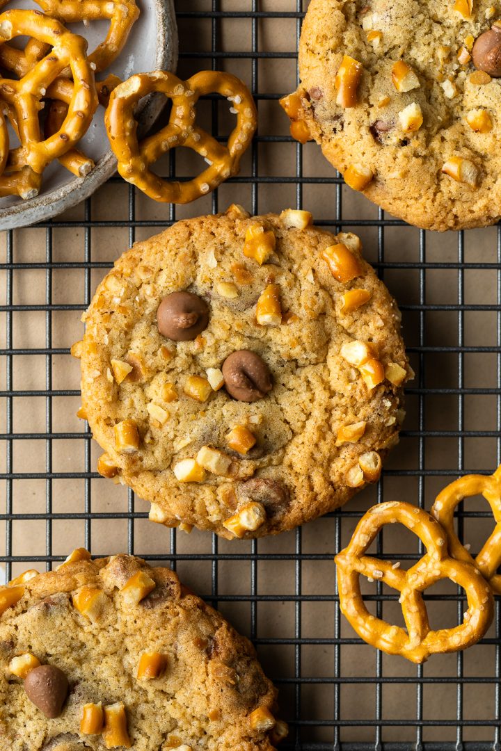 Close up of a chocolate chip pretzel cookie on a wire cooling rack