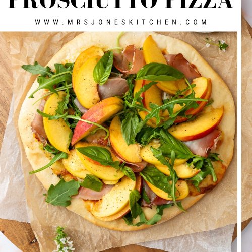 A peach pizza with prosciutto on a wooden board.