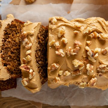 A coffee and walnut loaf cake with 3 slices cut from the left side.