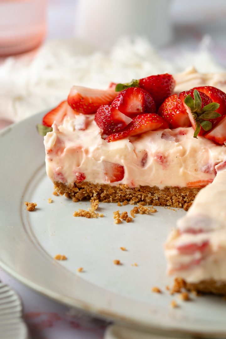Side view of the cheesecake with a slice cut out of it.