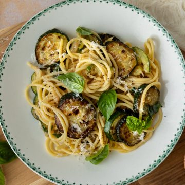 A bowl of courgette pasta sprinkled with fresh basil.