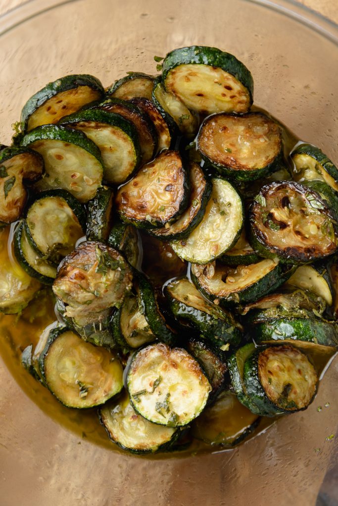 The fried zucchini / courgettes marinading in the dressing.