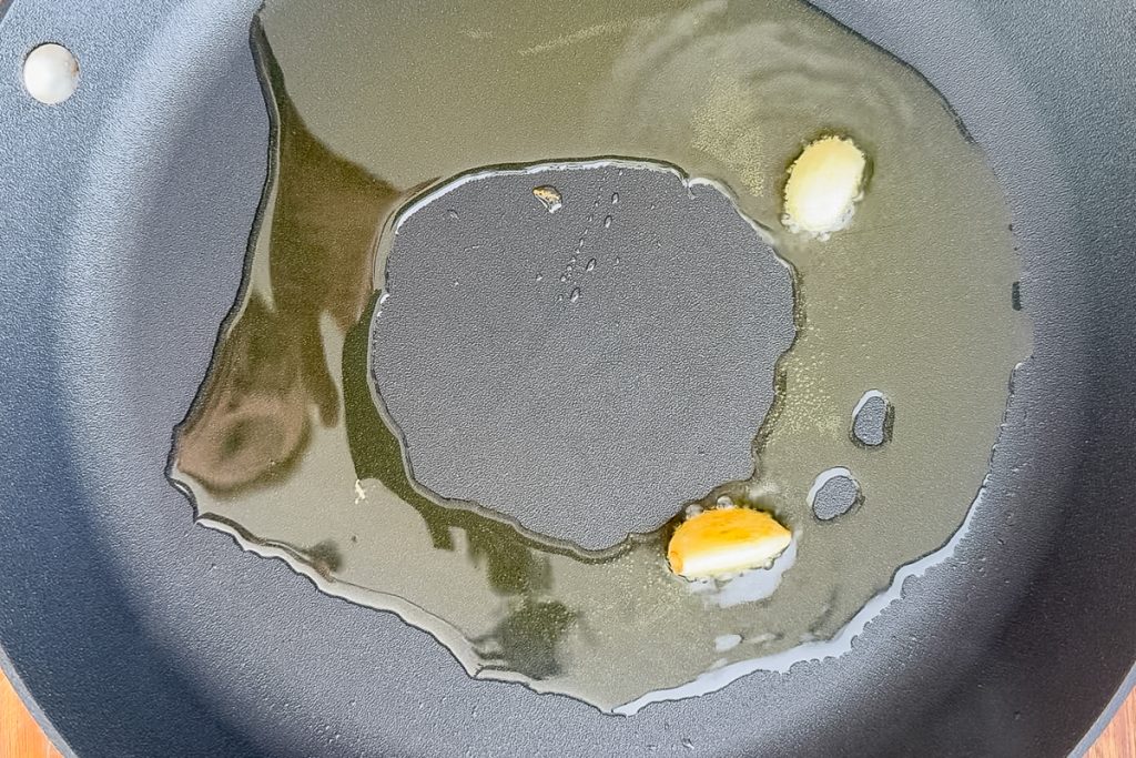 Golden cloves of garlic in the frying pan.