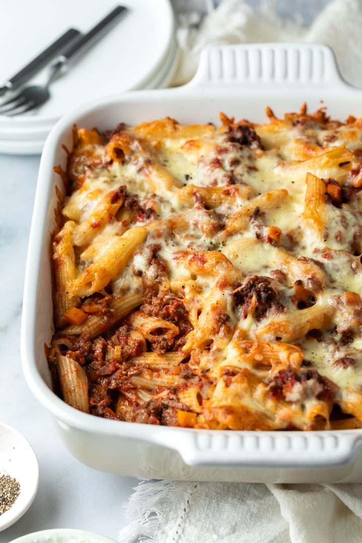 Side view of the baked pasta bolognese with a spoonful taken out.