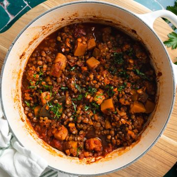 A pan of lentil ragu sprinkled with fresh parsley.