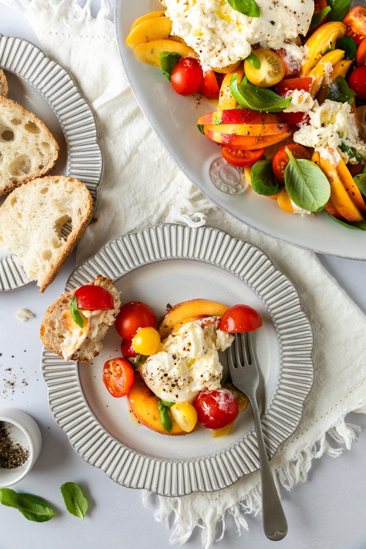 The served salad on a plate with bread.