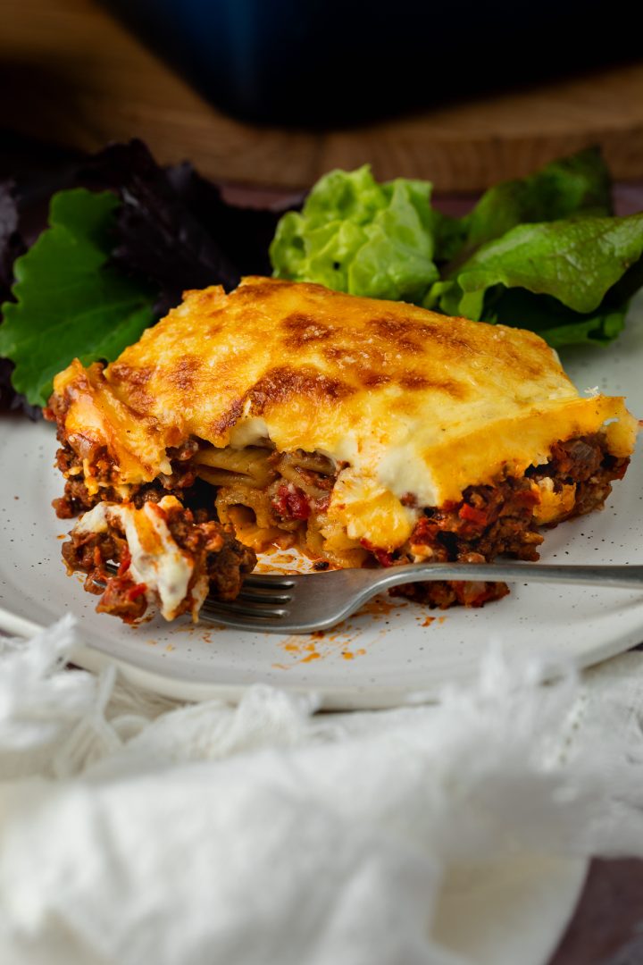 A side view of a portion of the Greek lasagna on a plate to show the layers.