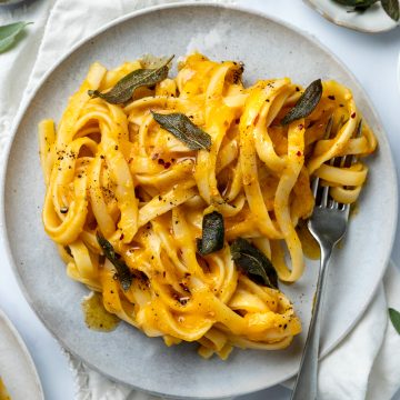 A plate of roasted butternut pasta topped with crispy sage.