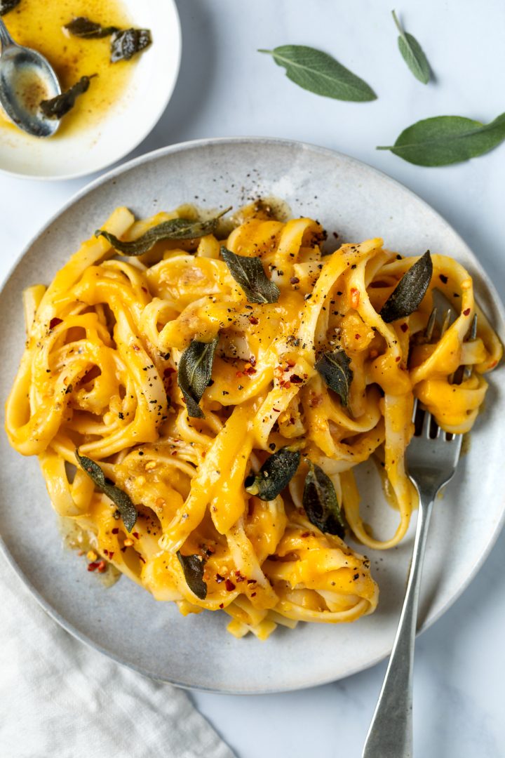 Close up of roasted butternut squash pasta topped with brown butter and crispy sage.