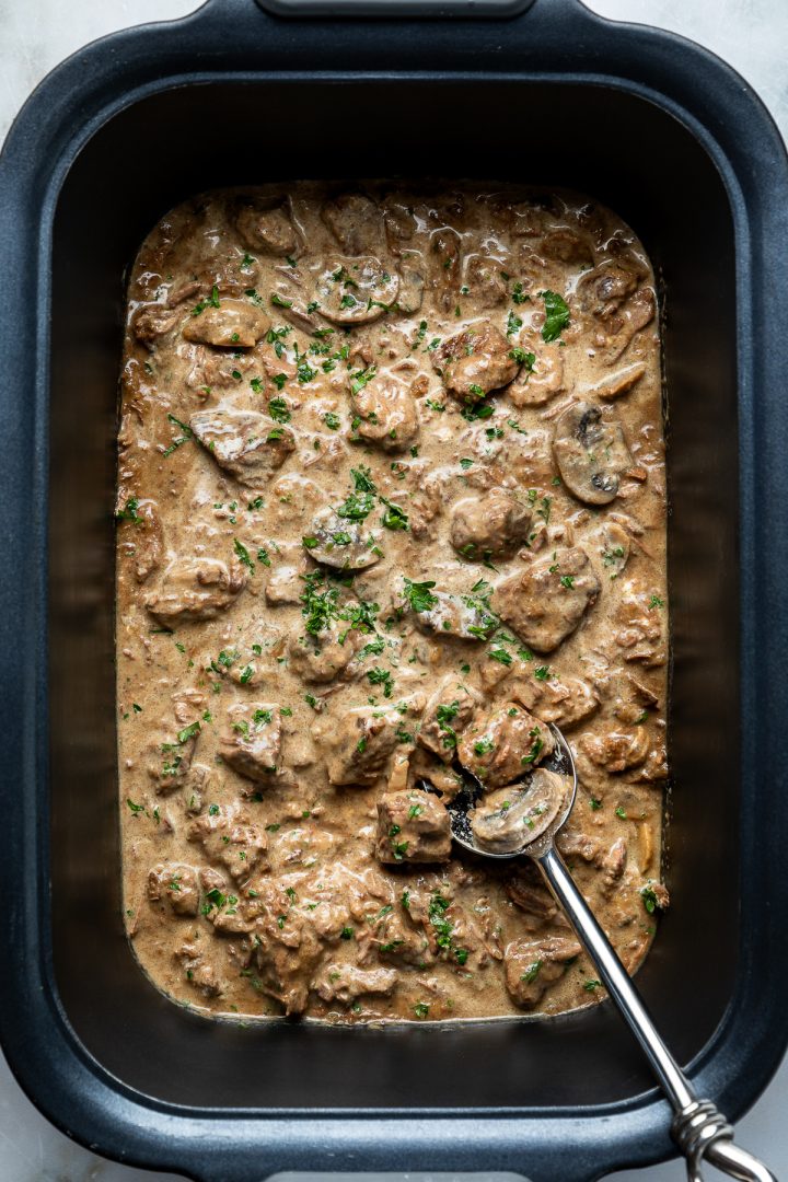 The cooked beef stroganoff in the slow cooker.