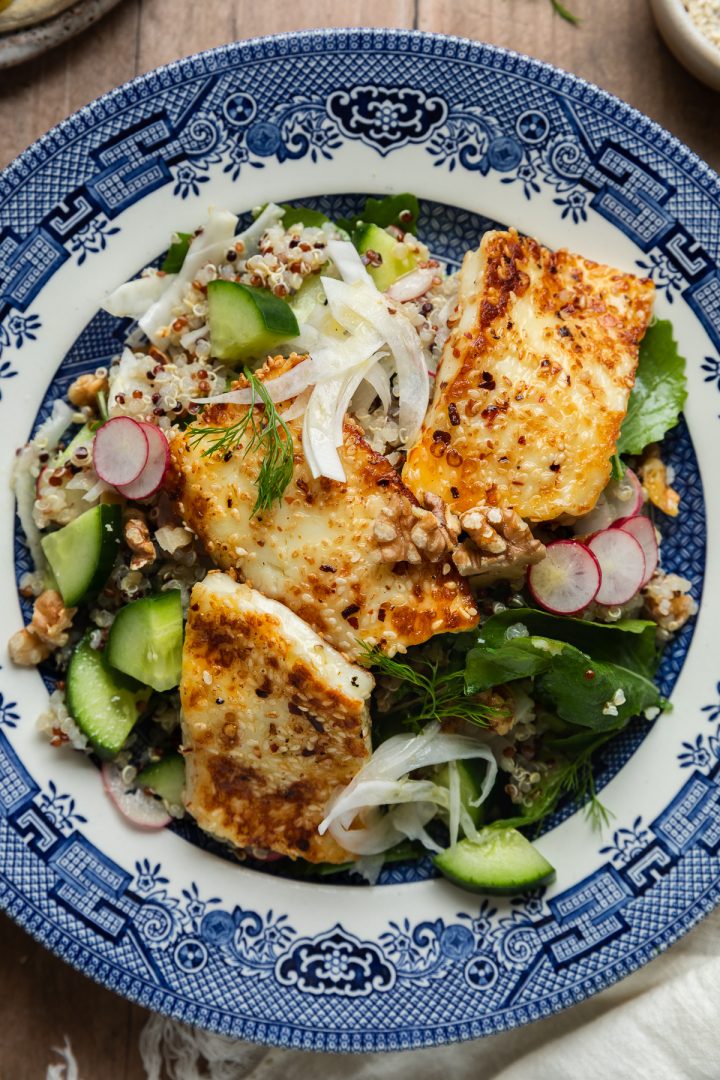 Close up of the served halloumi salad on a blue plate.