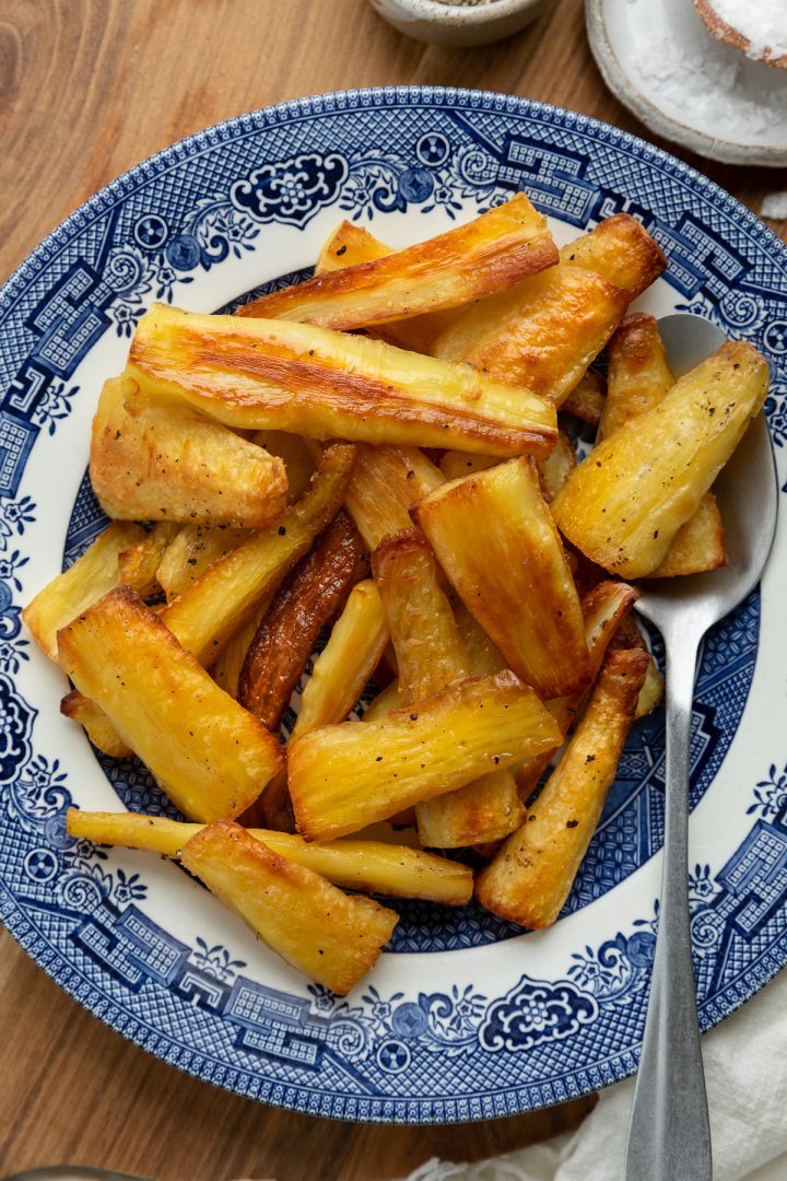 Close up of the roasted parsnips on a plate.
