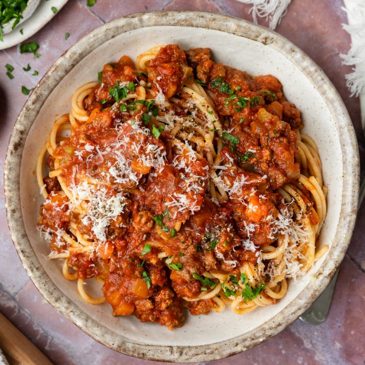 A bowl of slow cooker bolognese sauce and spaghetti.