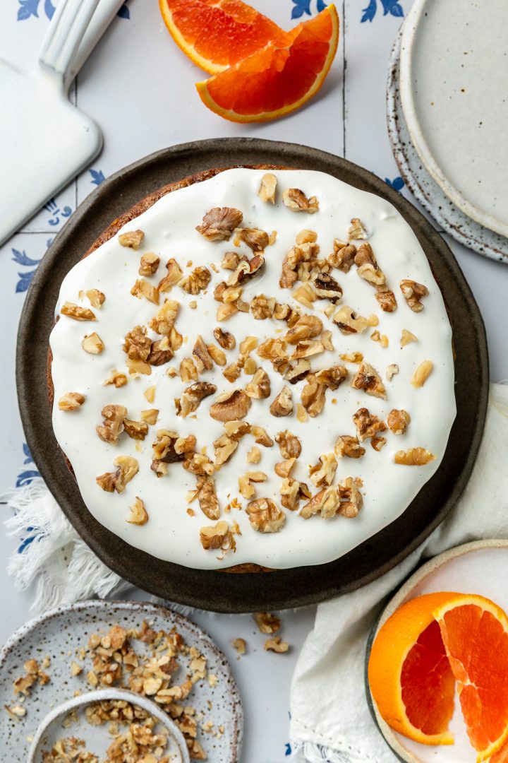 An overhead picture of the iced carrot cake topped with chopped walnuts.