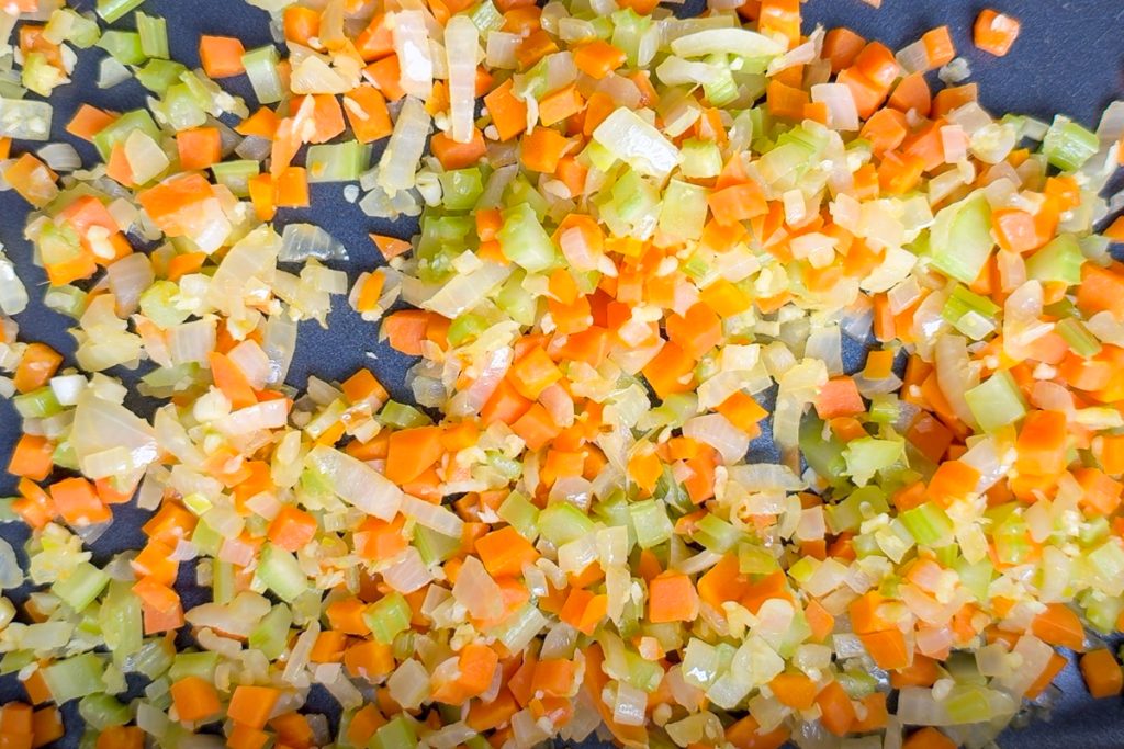 The softened vegetables in the slow cooker.
