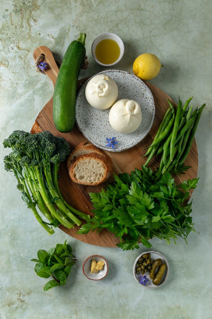 The ingredients needed to make the salad place on a wooden board.