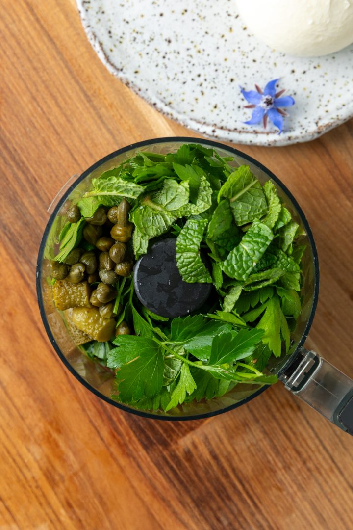The salsa verde ingredients in a mini food processor.