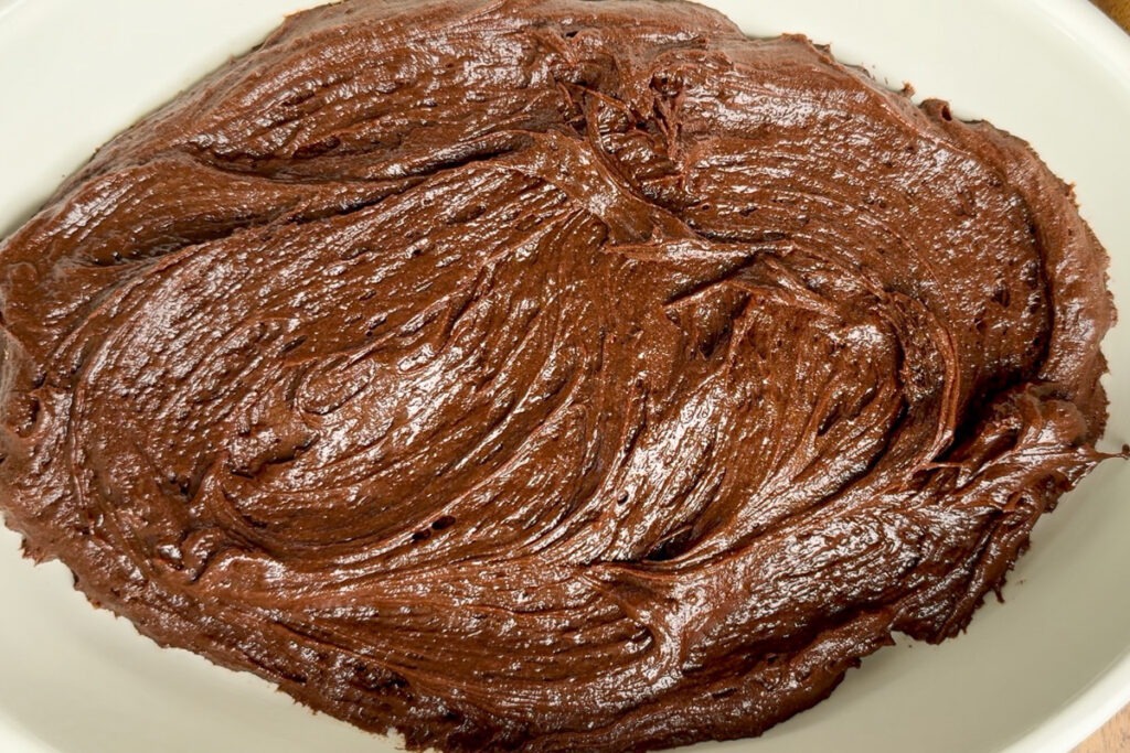 The chocolate sponge batter spread out into the baking dish.