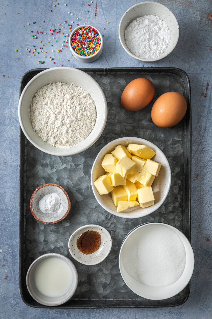 Ingredients needed to make the fairy cake recipe weighed out and placed in individual bowls.
