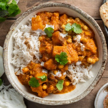 A bowl of butternut and chickpea curry served with rice.