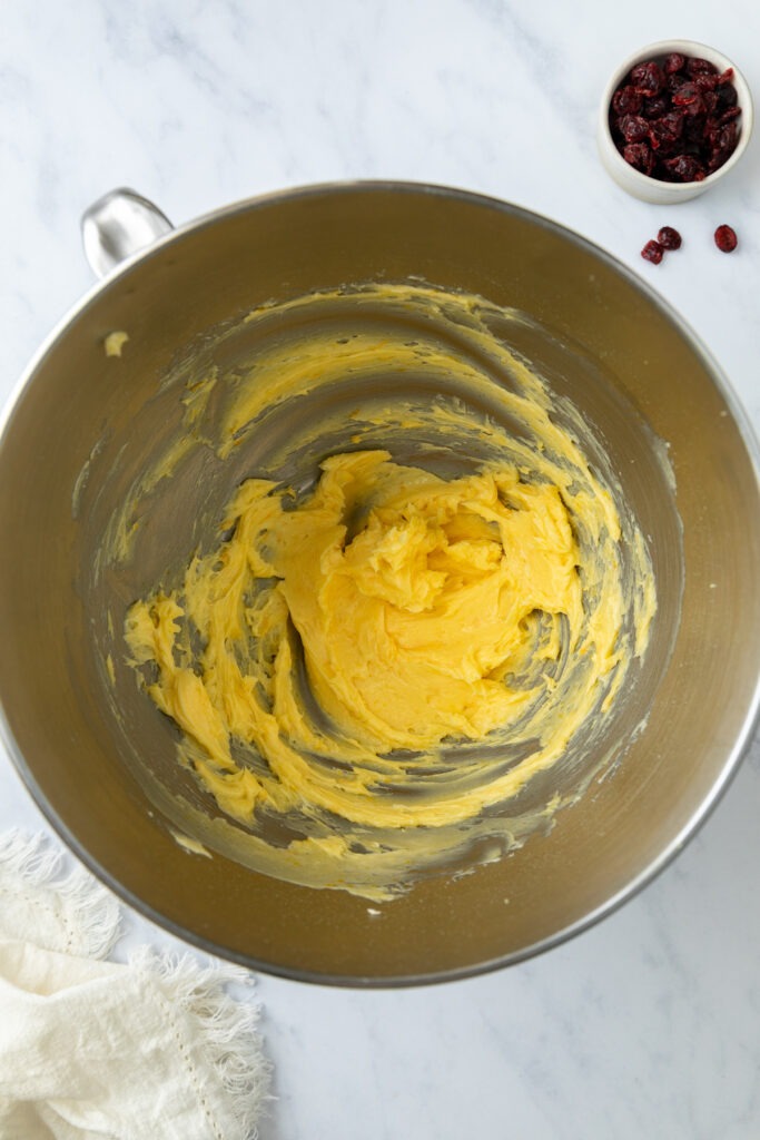 The creamed butter and sugar in a mixer bowl.