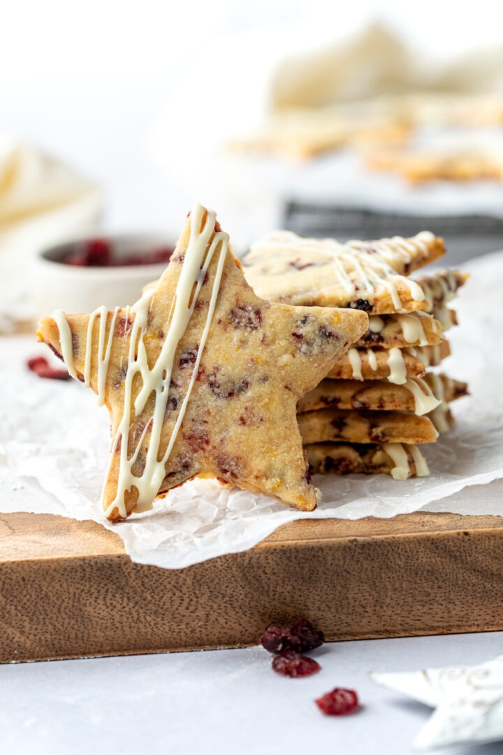 A stack of the shortbread stars with one on its side to show the finished decorated cookie.