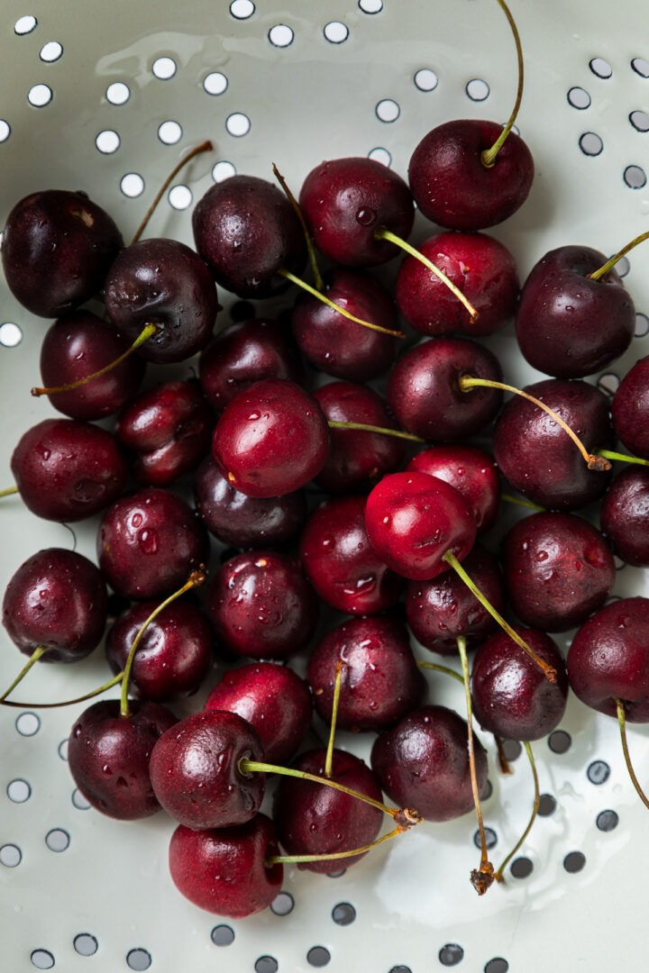 A colander of fresh cherries, just washed.