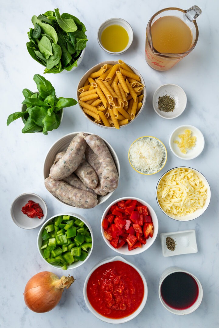 The ingredients needed to make the sausage pasta bake weighed in individual bowls.