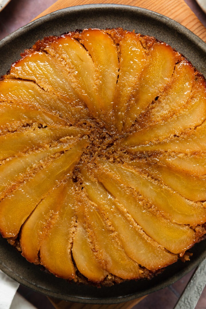 Close up of the base of the cake to show the layer of cooked pears on the bottom.