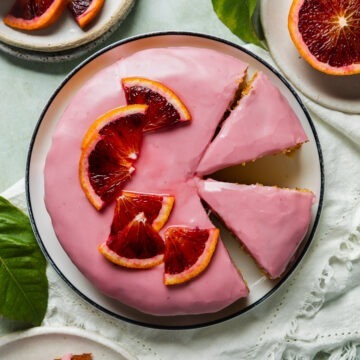 A homemade blood orange and almond cake topped with fresh blood orange.